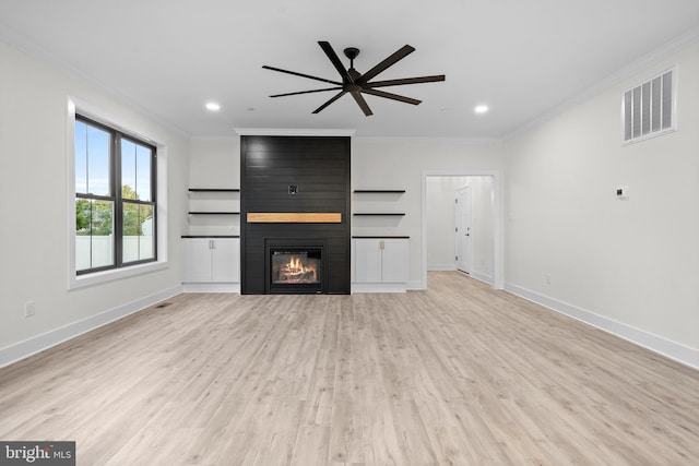 unfurnished living room with ceiling fan, ornamental molding, a fireplace, and light wood-type flooring