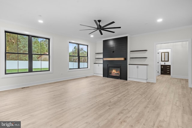 unfurnished living room featuring ceiling fan, ornamental molding, a fireplace, and light hardwood / wood-style floors