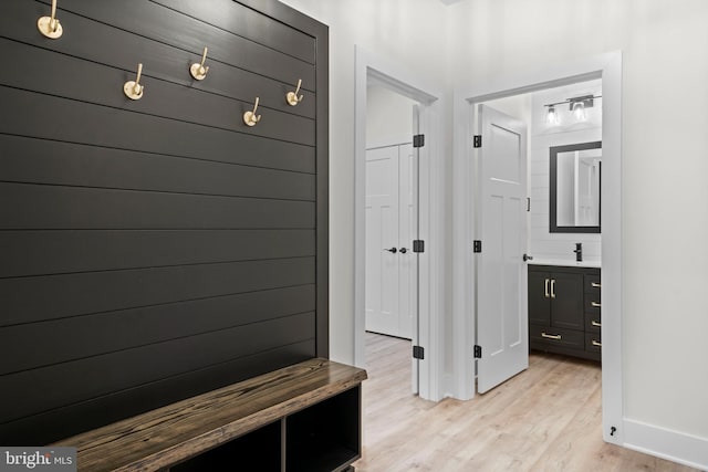 mudroom featuring sink and light hardwood / wood-style floors