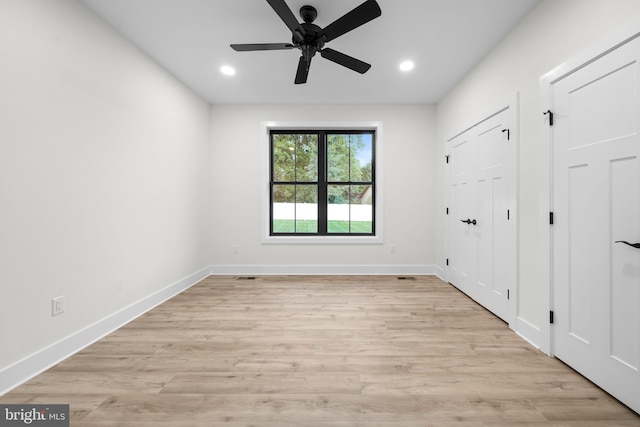 unfurnished bedroom with ceiling fan and light wood-type flooring