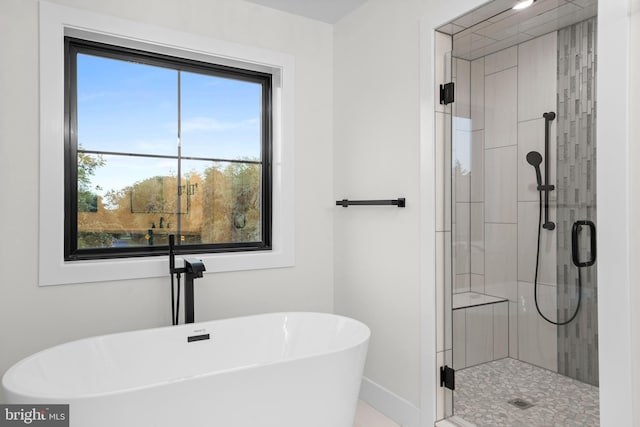 bathroom featuring separate shower and tub