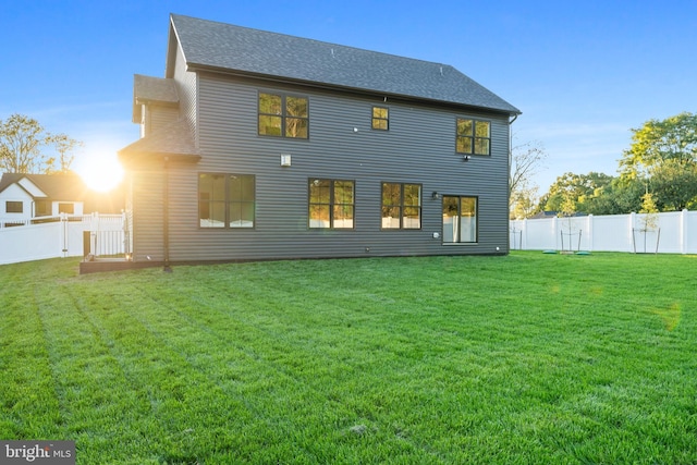 back of house with a lawn