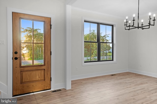 interior space featuring crown molding, plenty of natural light, and light hardwood / wood-style flooring