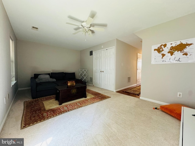 living room featuring ceiling fan and carpet flooring