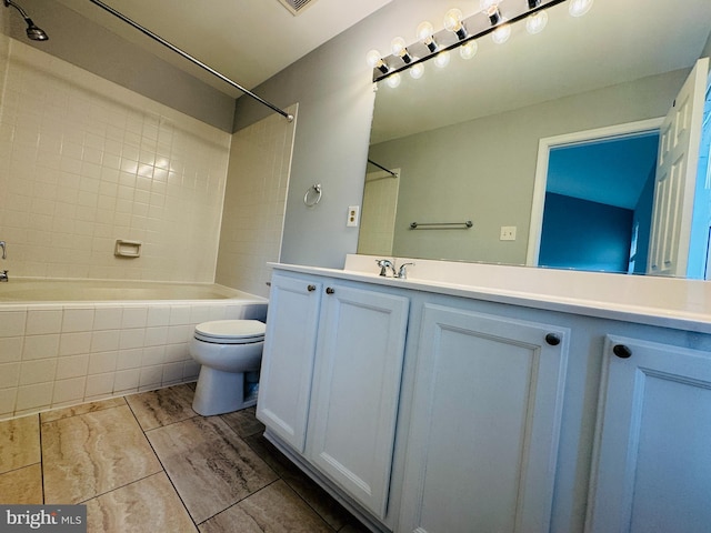 full bathroom featuring vanity, toilet, and tiled shower / bath combo