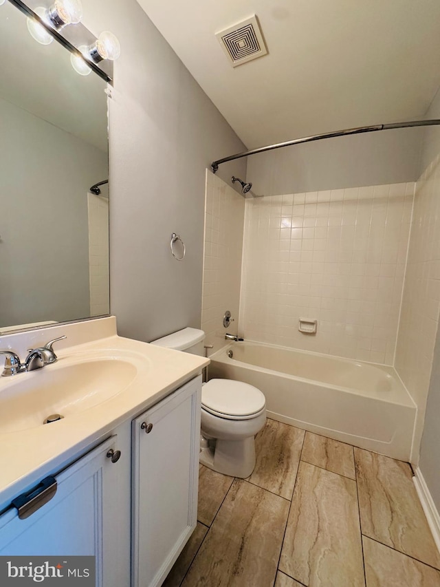 full bathroom with vanity, toilet, and tiled shower / bath combo