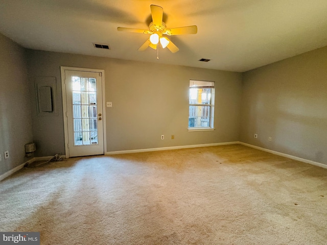 carpeted spare room with ceiling fan