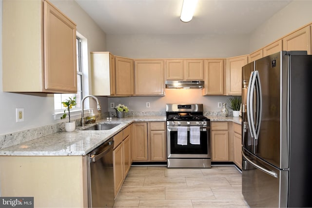 kitchen featuring light stone counters, appliances with stainless steel finishes, sink, and light brown cabinets