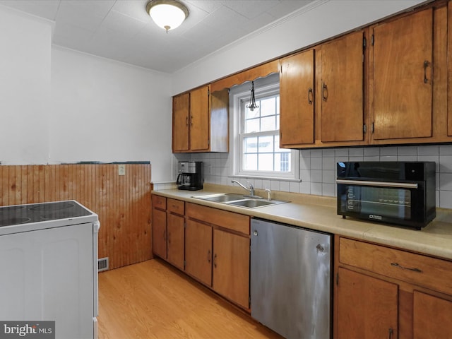 kitchen with dishwashing machine, sink, range with electric stovetop, ornamental molding, and light wood-type flooring