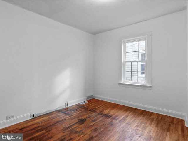 empty room with wood-type flooring