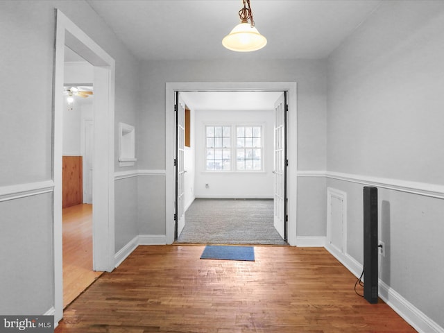 interior space with dark hardwood / wood-style flooring and ceiling fan