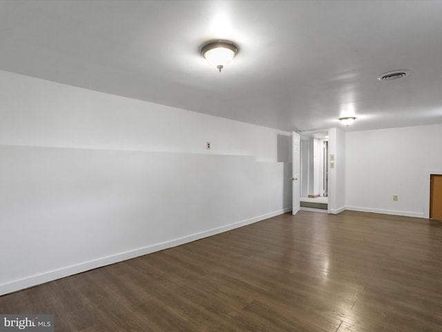 spare room with dark wood-type flooring