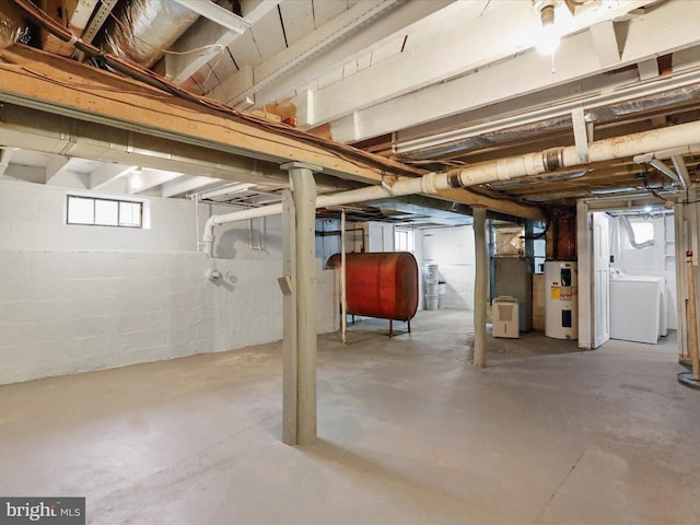 basement featuring washer / clothes dryer and water heater