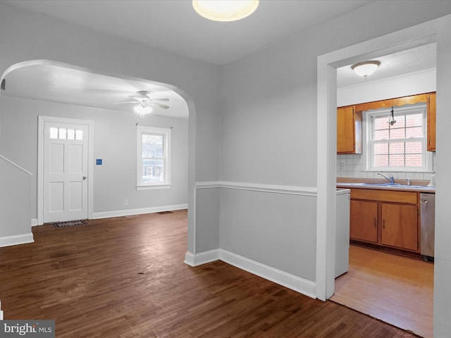 interior space with sink, plenty of natural light, and dark hardwood / wood-style floors