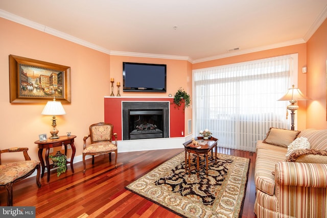 living room with hardwood / wood-style flooring and ornamental molding