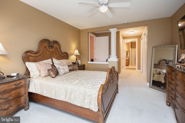 carpeted bedroom featuring ornate columns and ceiling fan