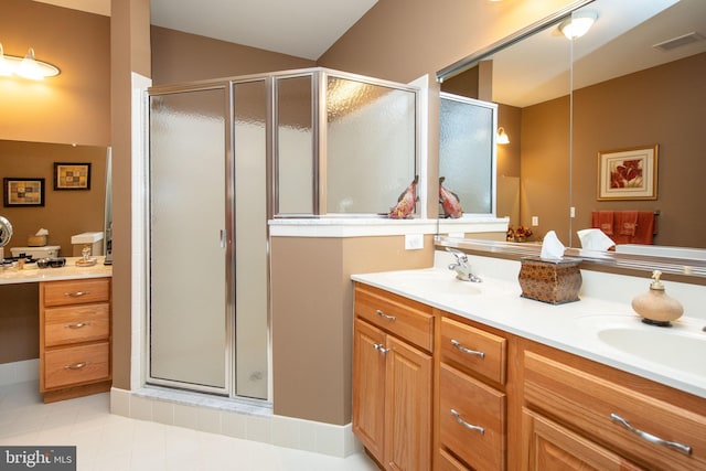 bathroom with walk in shower, vanity, tile patterned flooring, and vaulted ceiling