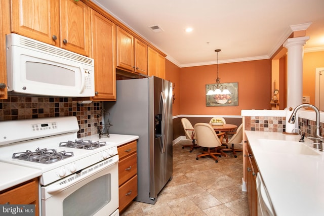 kitchen featuring pendant lighting, sink, backsplash, crown molding, and white appliances