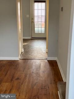 hallway with dark hardwood / wood-style floors