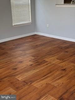 spare room with dark hardwood / wood-style flooring