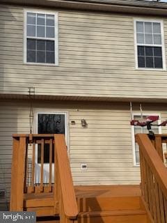 back of property with a wooden deck