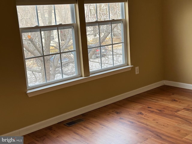 spare room with hardwood / wood-style floors