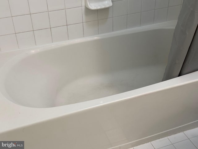 bathroom featuring tile patterned flooring and a bathing tub