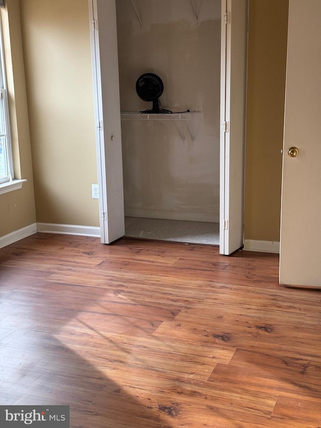 unfurnished bedroom featuring a closet and light hardwood / wood-style flooring