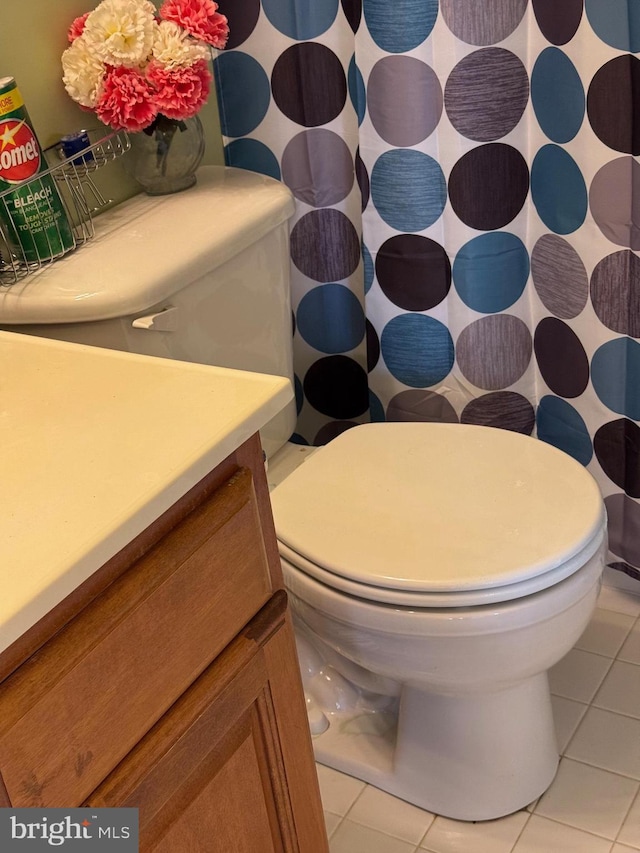 bathroom with vanity, tile patterned floors, and toilet