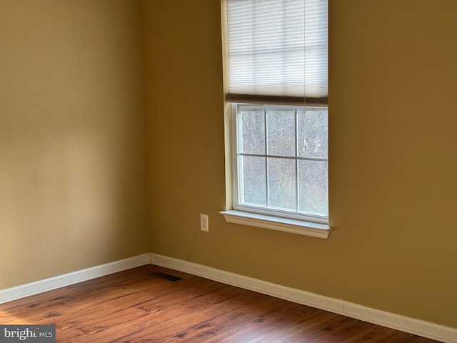 spare room featuring hardwood / wood-style floors