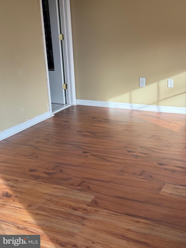 spare room with wood-type flooring