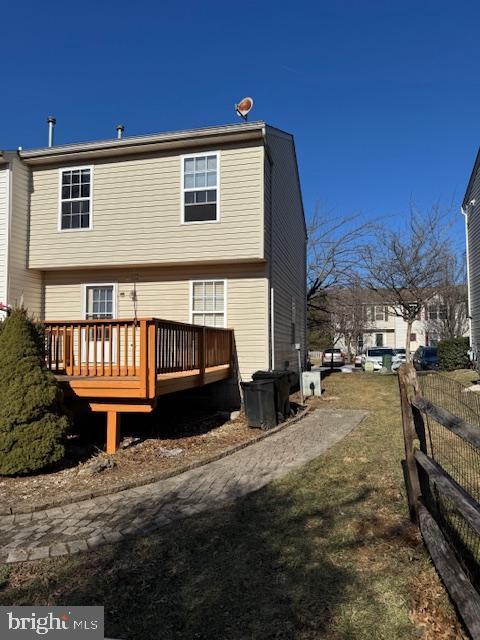 back of house featuring a wooden deck