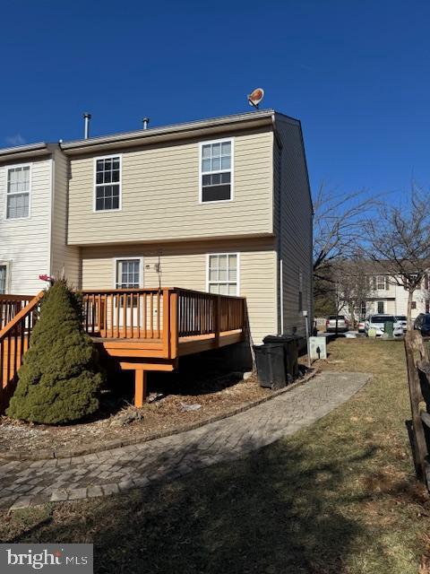 back of house featuring a wooden deck