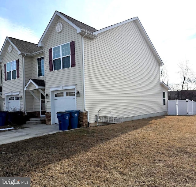 view of side of property with a garage and a yard