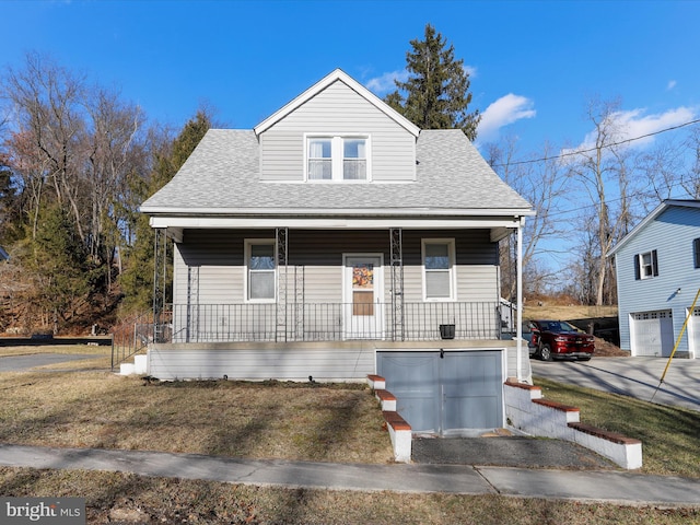 view of front of property featuring a garage and a porch