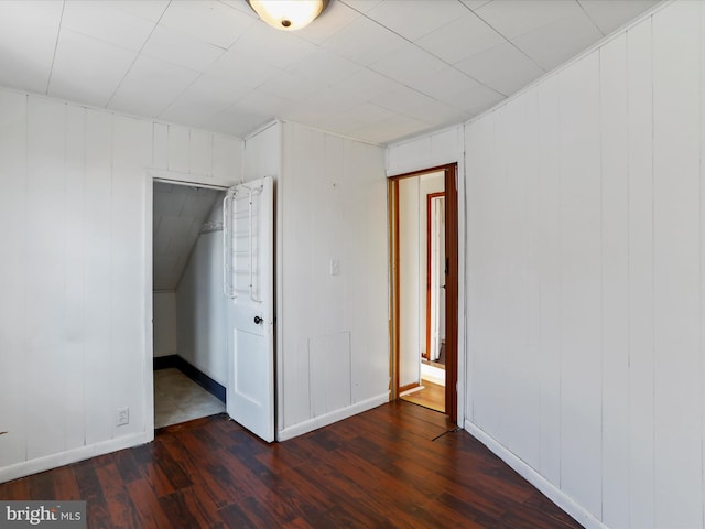 spare room featuring dark wood-type flooring