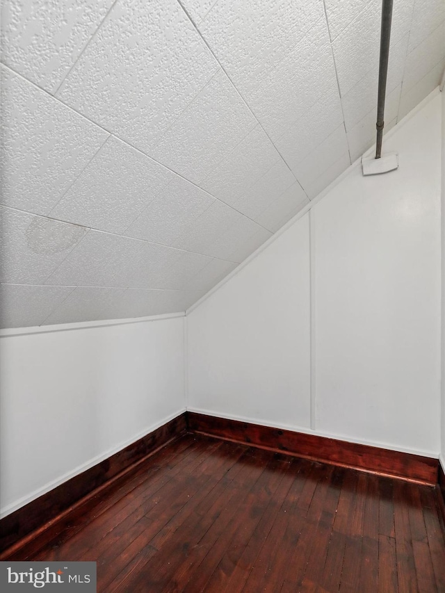 bonus room featuring hardwood / wood-style flooring and vaulted ceiling