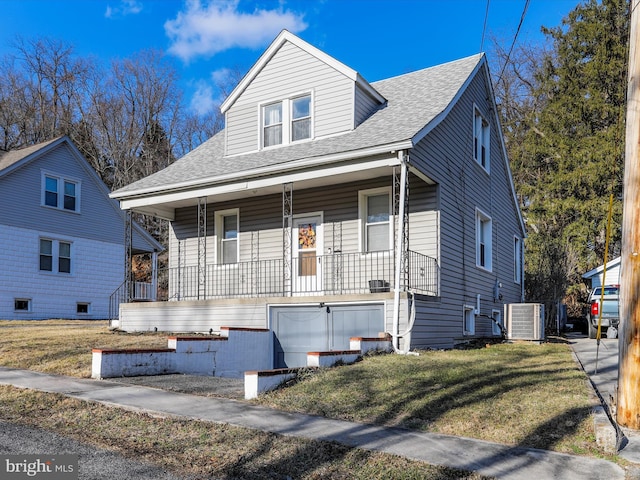 bungalow-style house featuring cooling unit, covered porch, and a front lawn