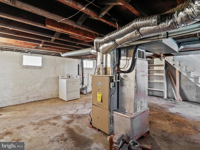 basement with heating unit and washer / dryer