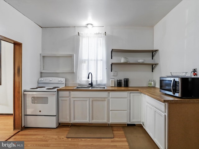 kitchen featuring white cabinetry, sink, light hardwood / wood-style floors, and white range with electric stovetop