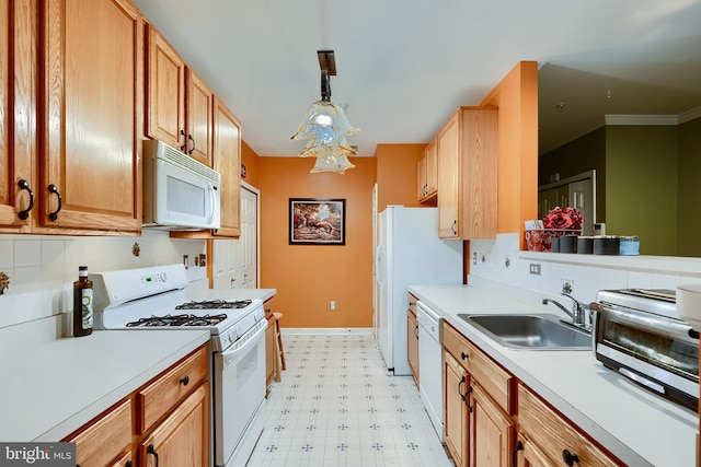 kitchen featuring tasteful backsplash, white appliances, sink, and hanging light fixtures