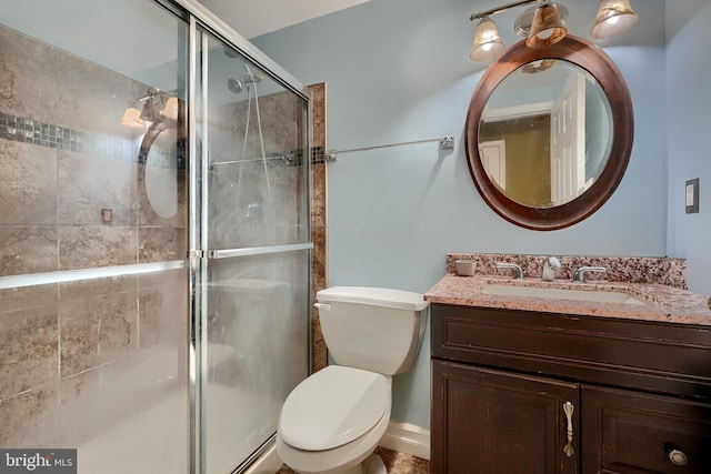 bathroom featuring vanity, toilet, and walk in shower