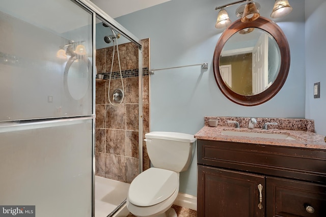 bathroom with vanity, an enclosed shower, and toilet