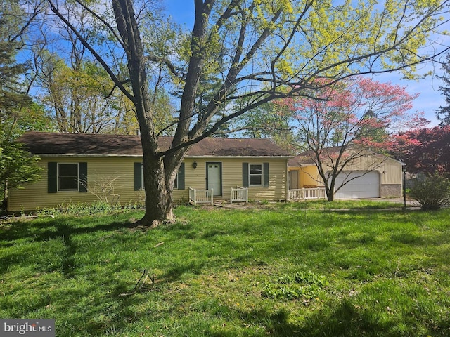 single story home with a garage and a front yard