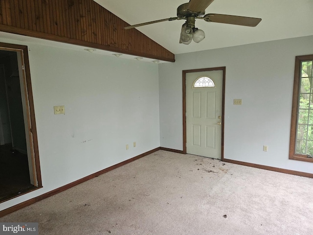 carpeted foyer featuring lofted ceiling and ceiling fan