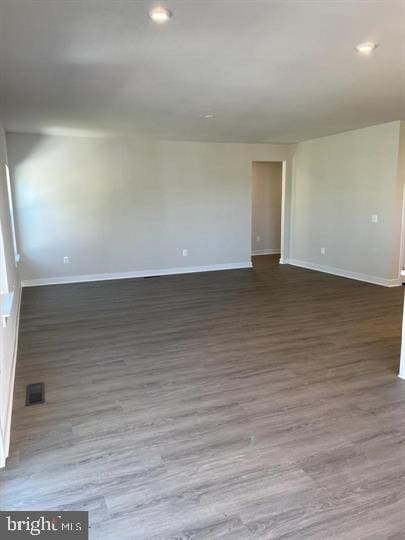 unfurnished room with dark hardwood / wood-style flooring