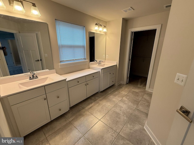 bathroom with tile patterned floors and vanity