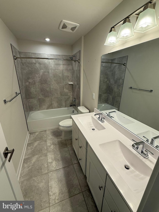 full bathroom featuring vanity, toilet, and tiled shower / bath combo