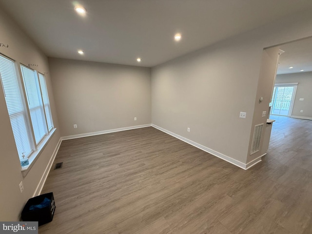 empty room with dark wood-type flooring