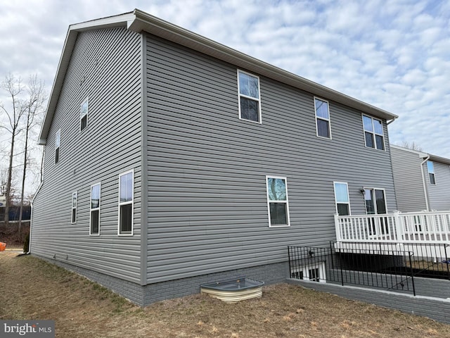 view of side of property with a deck